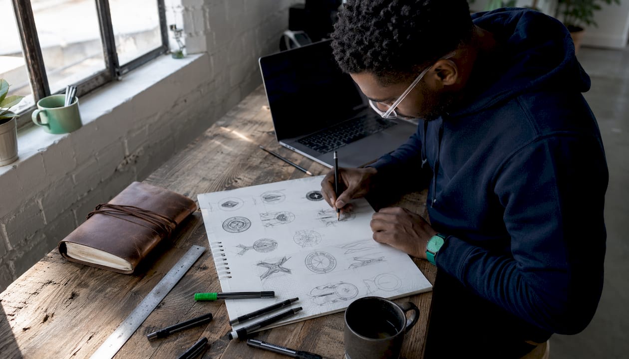 Designer sketching corporate medal designs