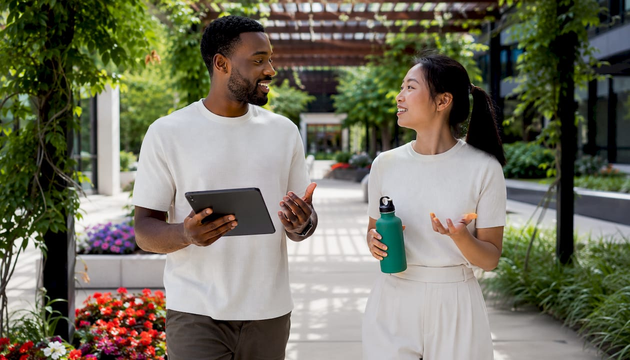 Two employees discussing wellness recognition ideas
