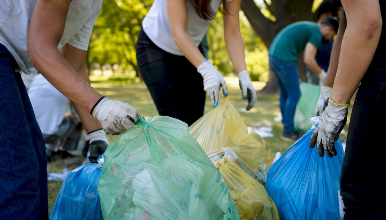 Hands picking up litter during volunteer event