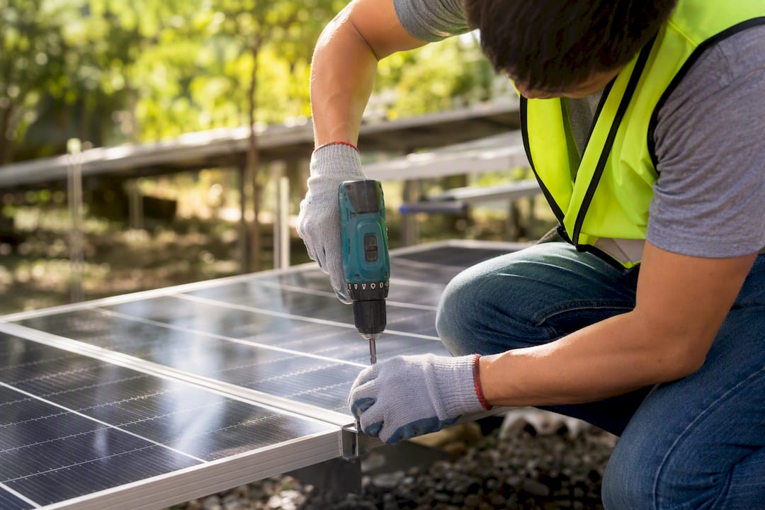 Volunteer working on solar panel installation