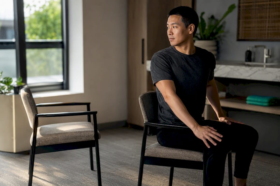 Employee performing a seated torso twist